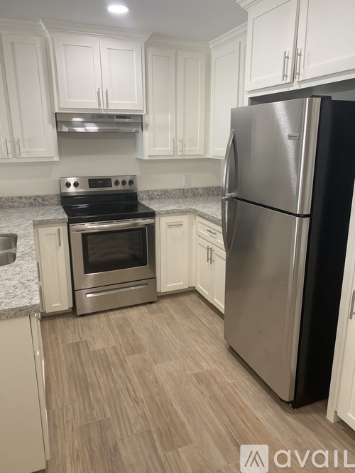 A kitchen with a stainless steel refrigerator and oven.