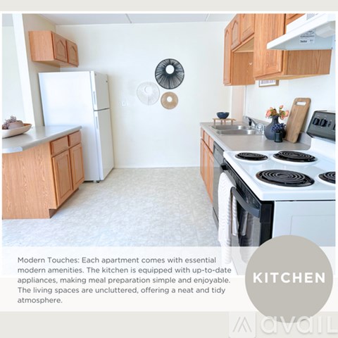 A kitchen with a white fridge, stove, and wooden cabinets.