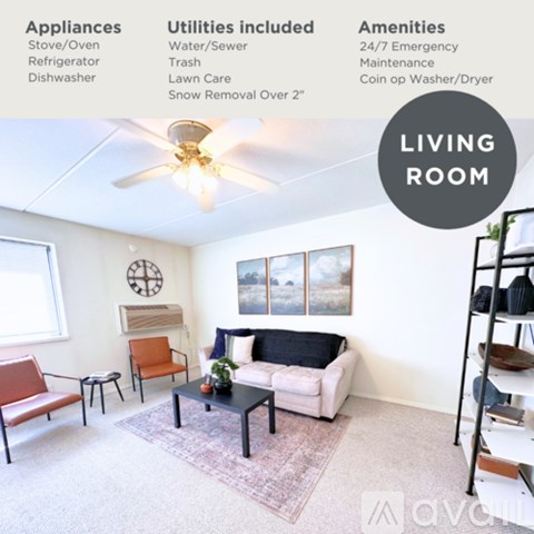 A living room with a sofa, chairs, and a ceiling fan.