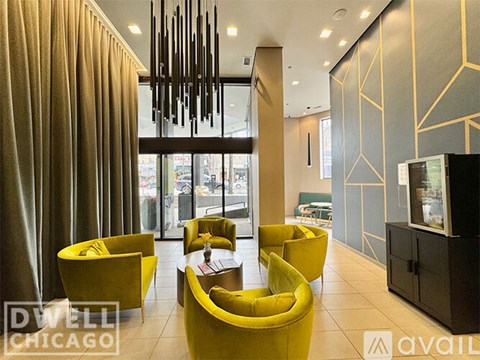 A modern living room with yellow chairs and a television.