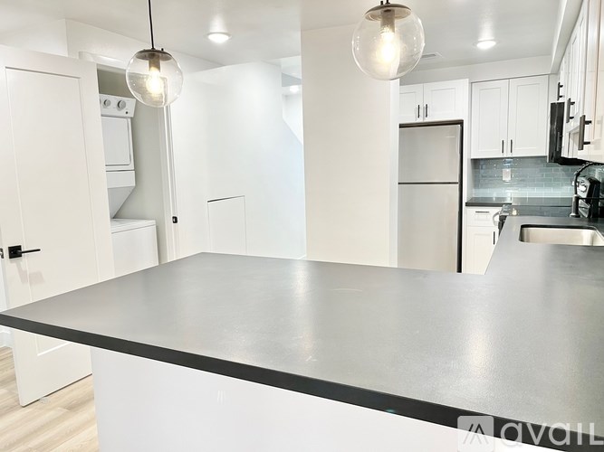 A modern kitchen with a large island in the center.