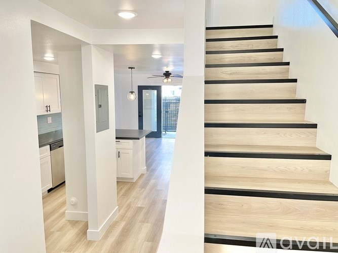 A modern interior with a staircase leading to the upper floor.