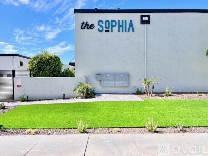 A white building with a blue sign that says "the sophia".