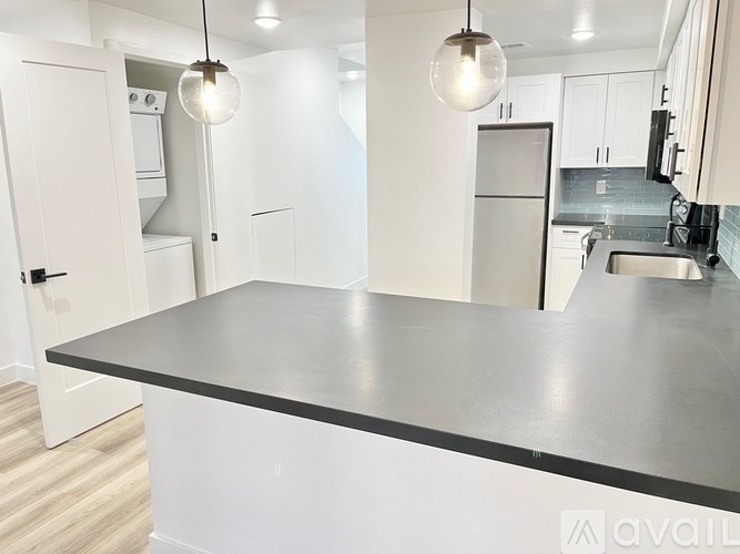 A kitchen with a large island in the middle.