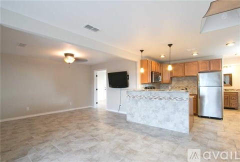 A kitchen with a white fridge and a white counter top.