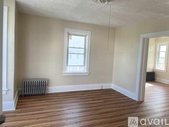A room with wooden floors and a window.