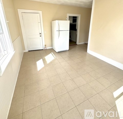 A room with wooden floors and a window.