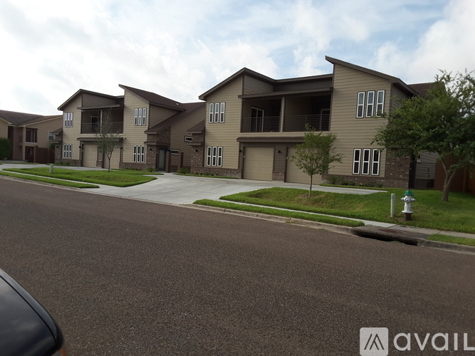 A row of houses with a car parked in front.