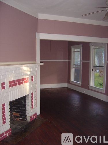 A room with a fireplace and a window.
