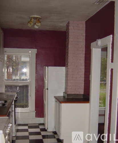 A kitchen with a black and white checkered floor.