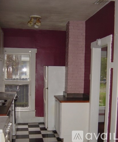 A kitchen with a black and white checkered floor.