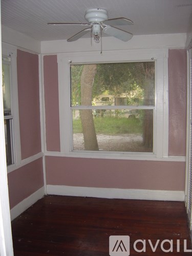 A room with a window and a fan.