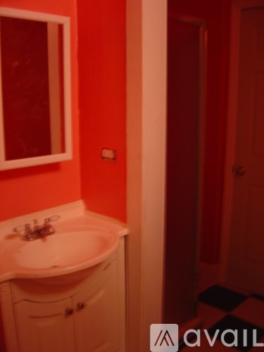 A white sink in a small bathroom.