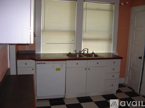 A kitchen with a sink and cabinets.