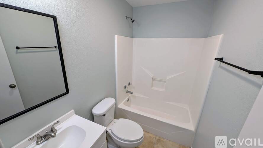 A bathroom with a toilet, sink, and bathtub.