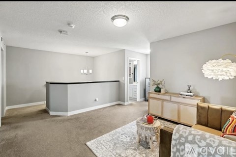 A living room with a brown couch and a grey cabinet.