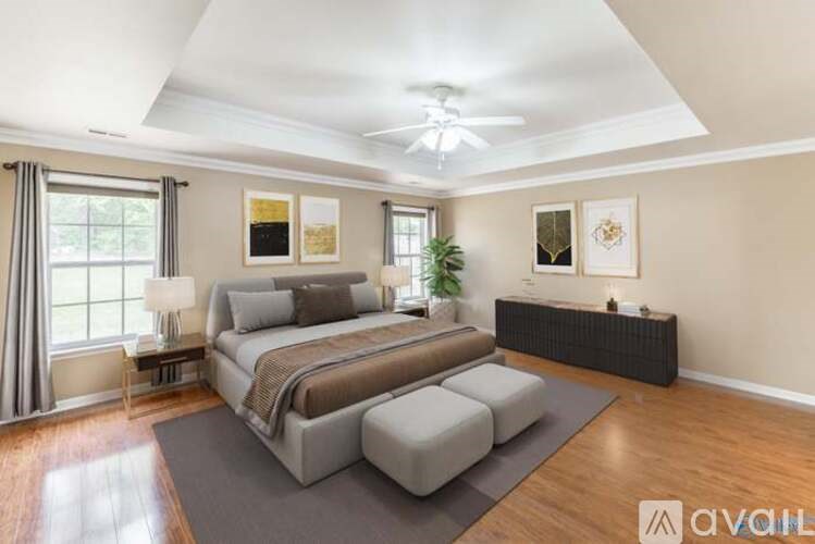 A bedroom with a large bed and a ceiling fan.
