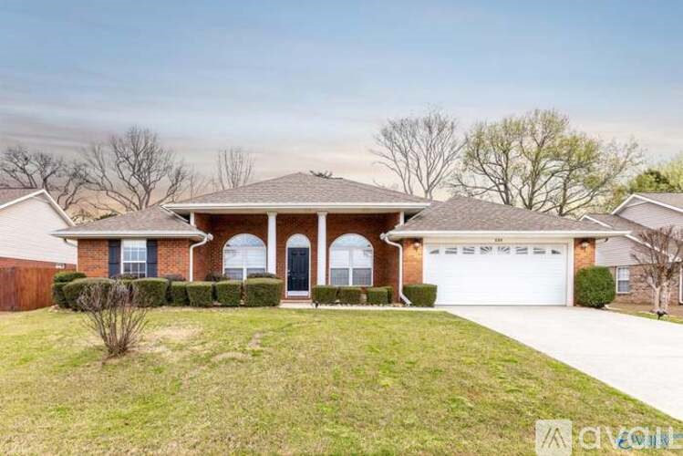 A house with a brick facade and a white garage door.