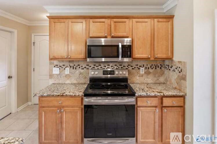 A kitchen with wooden cabinets and granite countertops.