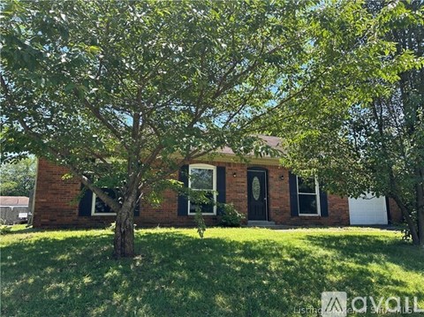 A house with a tree in front of it.