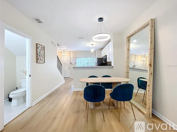 A dining room with a wooden table and chairs.