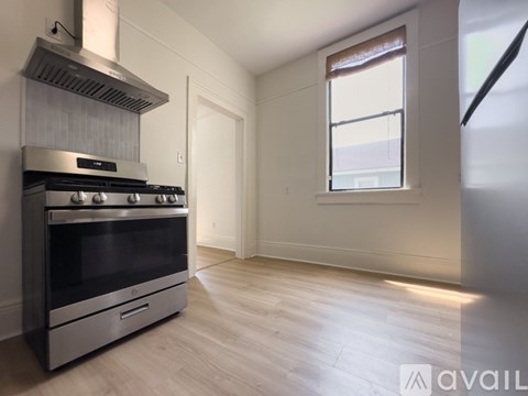 A modern kitchen with a stainless steel oven and a window.