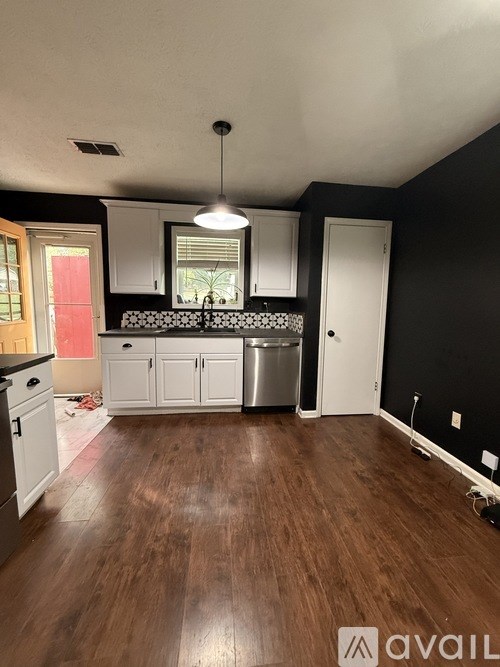 A window sill with a variety of plants and candles.