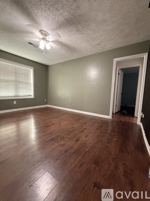 A white toilet sits in a bathroom next to a bathtub.