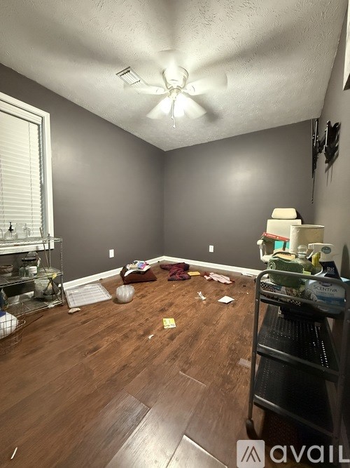 A room with a lot of clutter on the floor.