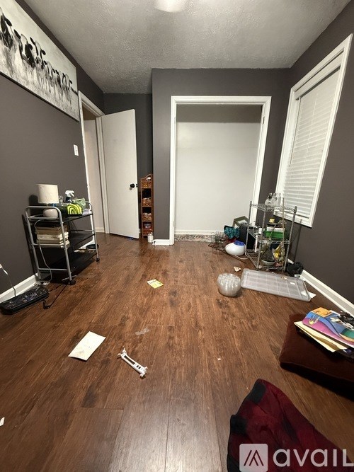 A room with wooden flooring and a white door.