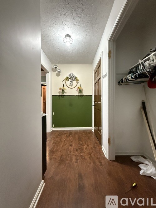 A street view of a residential area with houses and greenery.
