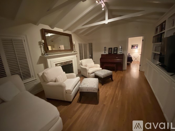 A living room with a fireplace and a mirror on the wall.
