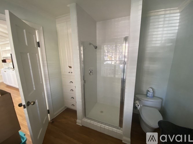 A bathroom with a toilet, sink, and shower.