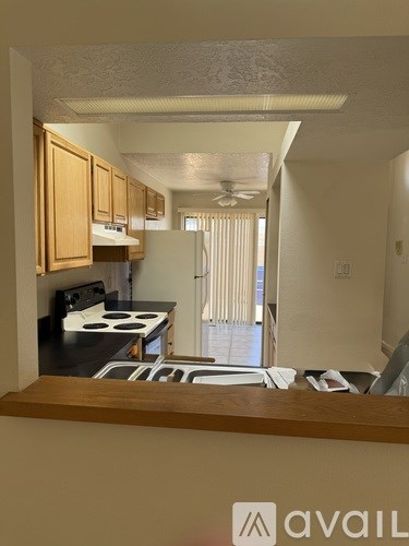 A kitchen with wooden cabinets and a stove top oven.