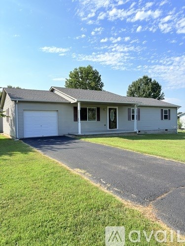 A house with a garage is for sale.