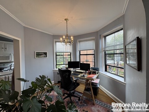 A well-lit room with a desk and a chair.
