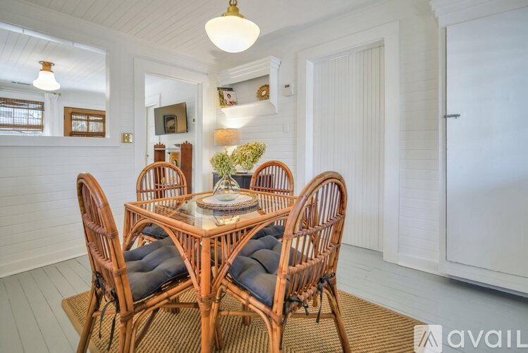 A dining room with a wooden table and chairs.