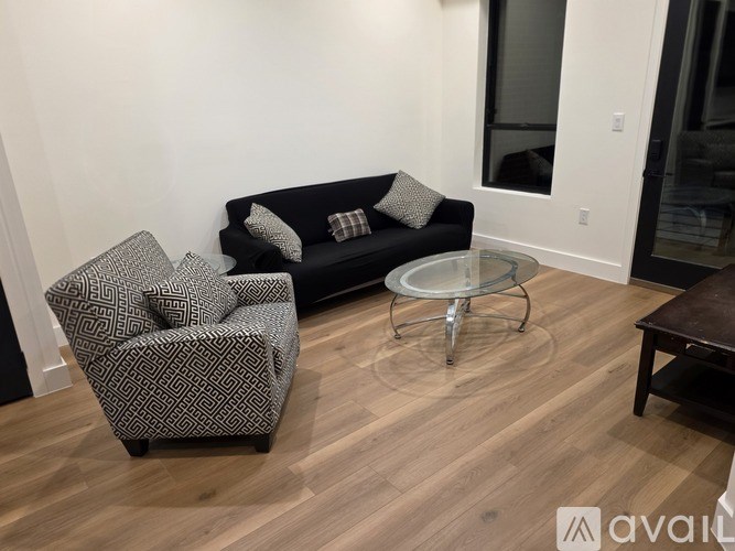 A bedroom with a large bed and a view of the outside through the window.