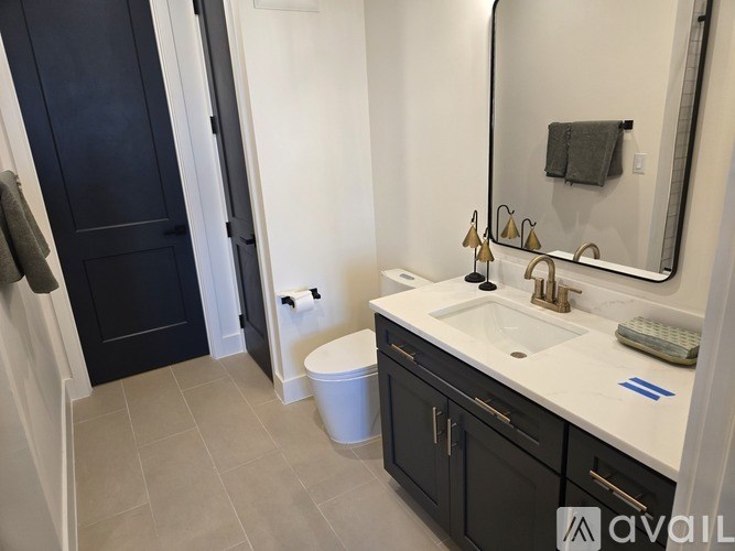 A bathroom with a white sink and a mirror above it.