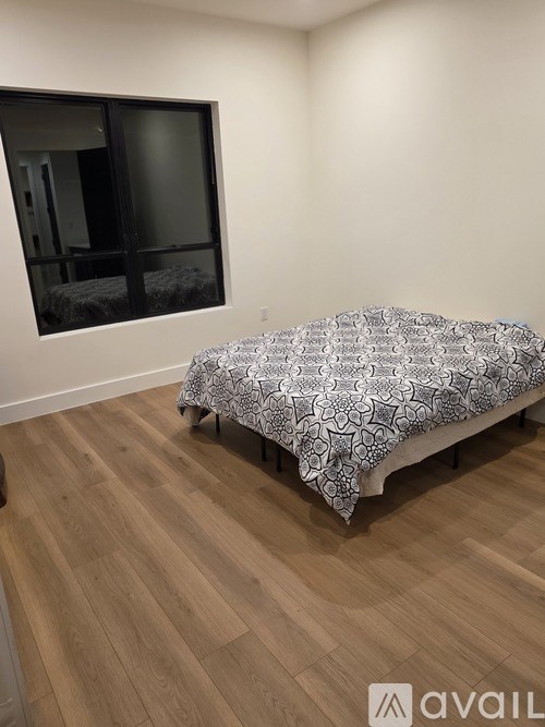 A modern gym with a variety of equipment including a treadmill, stationary bike, and weight machines.