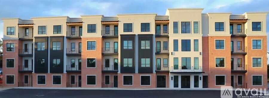 A row of modern townhouses with balconies and windows.