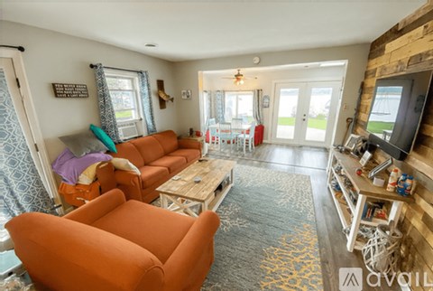 A living room with a brown sofa and a wooden coffee table.