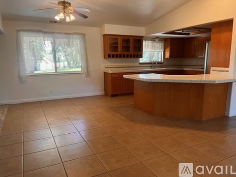 A kitchen with brown cabinets and a white countertop.