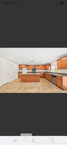 A kitchen with wooden cabinets and a central island.