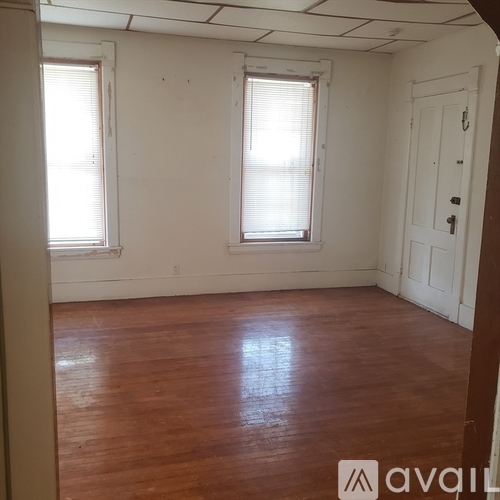 A room with wooden floors and white walls.