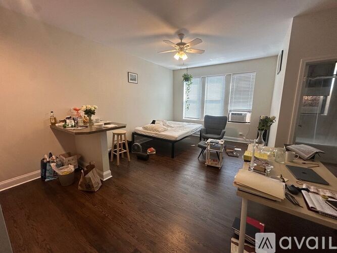 A room with a bed, desk, and chair.