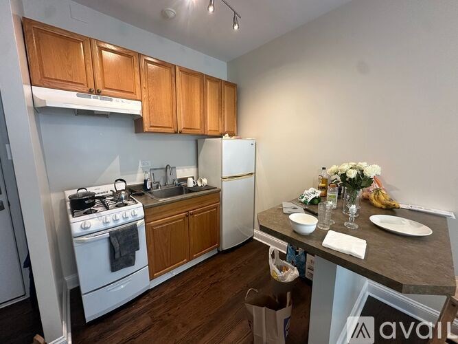A kitchen with wooden cabinets and a white refrigerator.