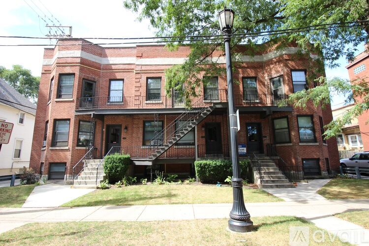 A red brick building with a black lamp post in front.