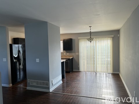 A living room with a television and a bar area.