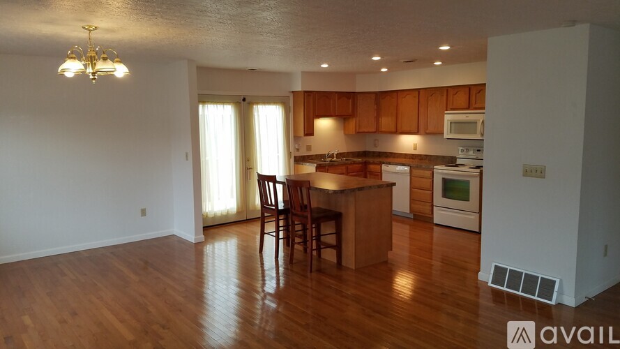 A kitchen with wooden floors and a dining table.